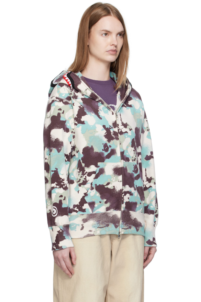 French terry hoodie.

· Logo camouflage pattern printed throughout
· Printed graphic and graphic appliqués at hood
· Two-way zip closure extends to hood
· Patch pockets at front
· Rib-knit hem and cuffs
· Logo flag at cuff

Supplier color: Multi