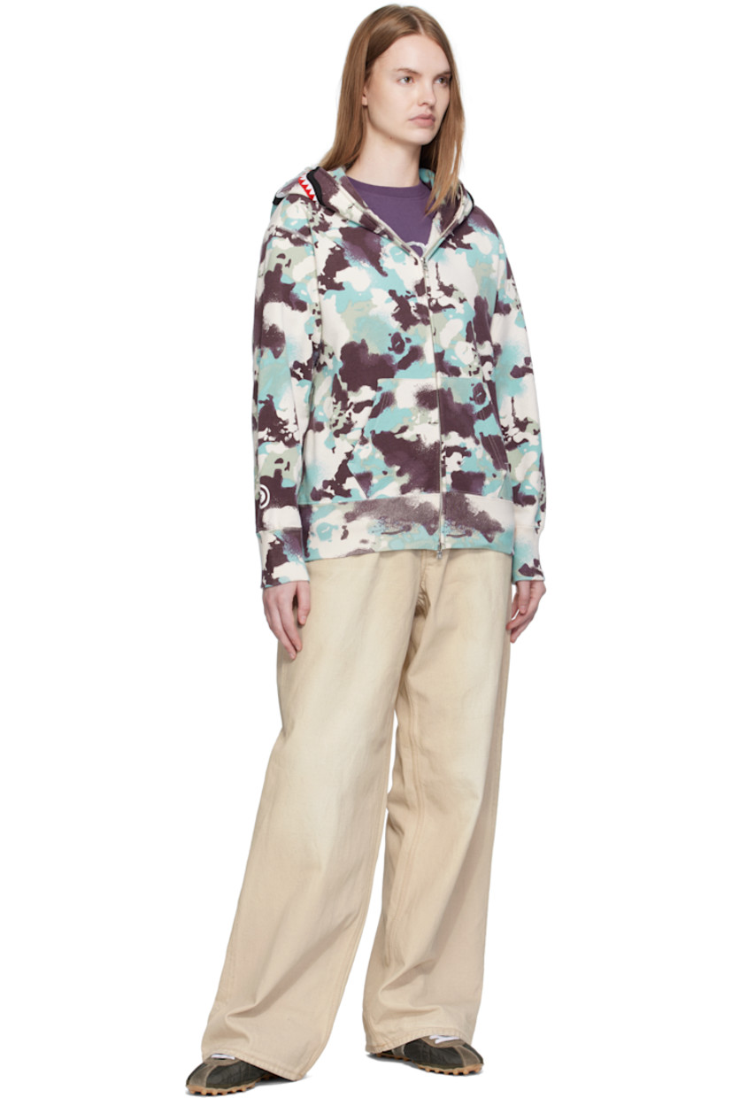 French terry hoodie.

· Logo camouflage pattern printed throughout
· Printed graphic and graphic appliqués at hood
· Two-way zip closure extends to hood
· Patch pockets at front
· Rib-knit hem and cuffs
· Logo flag at cuff

Supplier color: Multi