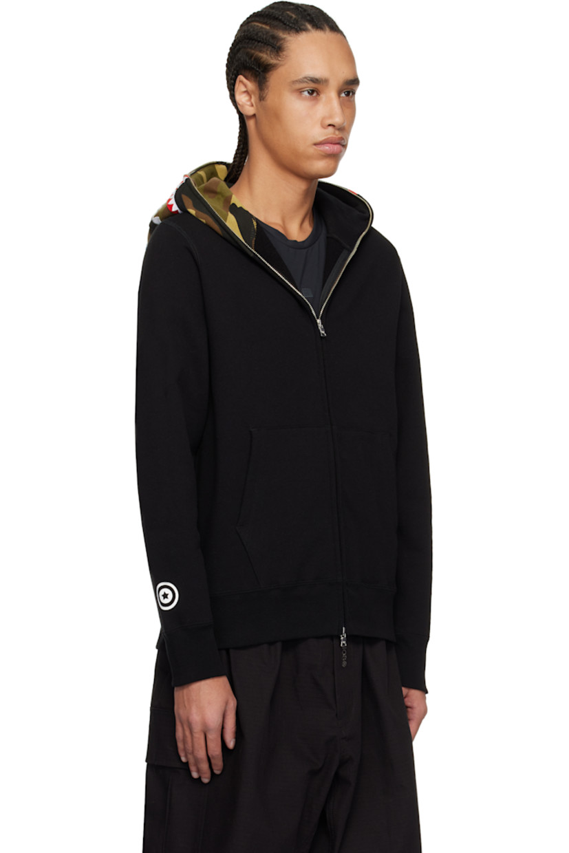 Cotton fleece hoodie. Printed logo camouflage pattern, printed graphic, and graphic appliqués at hood.

· Two-way zip closure extends to hood 
· Embroidered logo patch at chest
· Patch pockets
· Rib-knit hem and cuffs
· Dropped shoulders
· Printed graphic at cuff
· Logo flag at cuff

Supplier color: Black