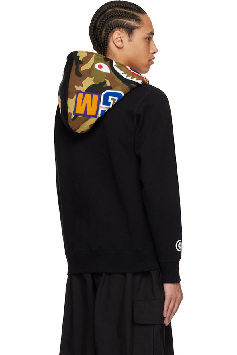 Cotton fleece hoodie. Printed logo camouflage pattern, printed graphic, and graphic appliqués at hood.

· Two-way zip closure extends to hood 
· Embroidered logo patch at chest
· Patch pockets
· Rib-knit hem and cuffs
· Dropped shoulders
· Printed graphic at cuff
· Logo flag at cuff

Supplier color: Black