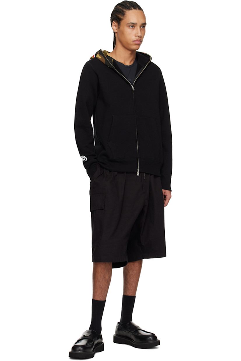 Cotton fleece hoodie. Printed logo camouflage pattern, printed graphic, and graphic appliqués at hood.

· Two-way zip closure extends to hood 
· Embroidered logo patch at chest
· Patch pockets
· Rib-knit hem and cuffs
· Dropped shoulders
· Printed graphic at cuff
· Logo flag at cuff

Supplier color: Black