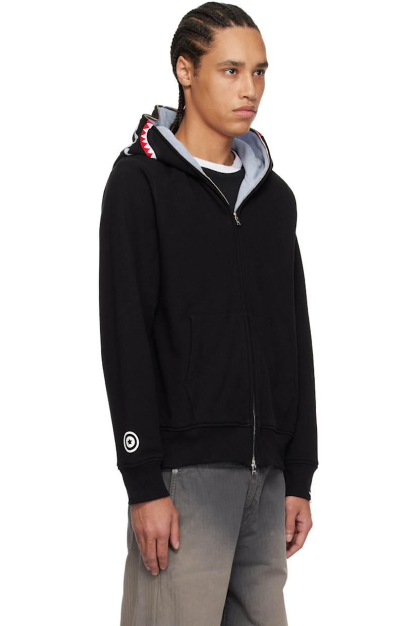 Cotton fleece hoodie. 

· Felted graphic appliqués and embroidered text at hood
· Two-way zip closure extends to hood 
· Patch pockets
· Rib-knit hem and cuffs
· Printed graphic at cuff
· Logo flag at cuff
· Full waffle-knit lining

Supplier color: Black