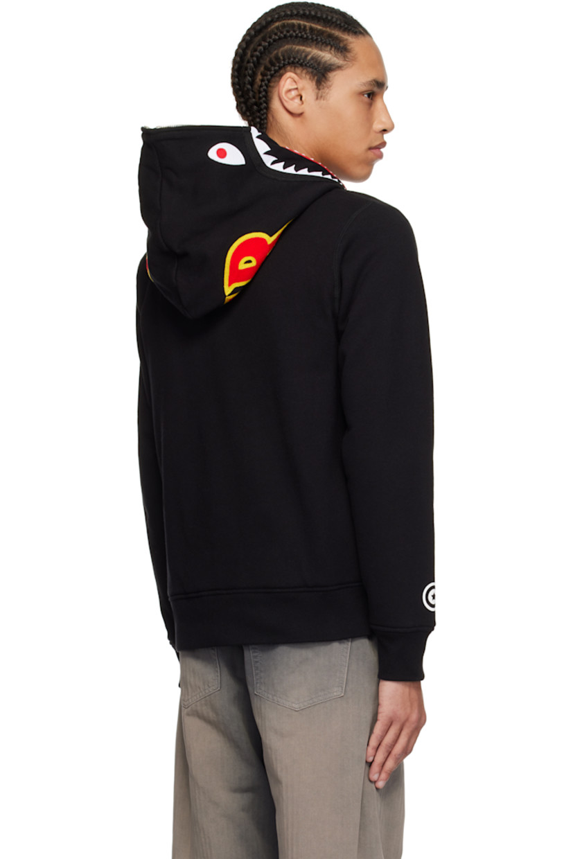 Cotton fleece hoodie. 

· Felted graphic appliqués and embroidered text at hood
· Two-way zip closure extends to hood 
· Patch pockets
· Rib-knit hem and cuffs
· Printed graphic at cuff
· Logo flag at cuff
· Full waffle-knit lining

Supplier color: Black