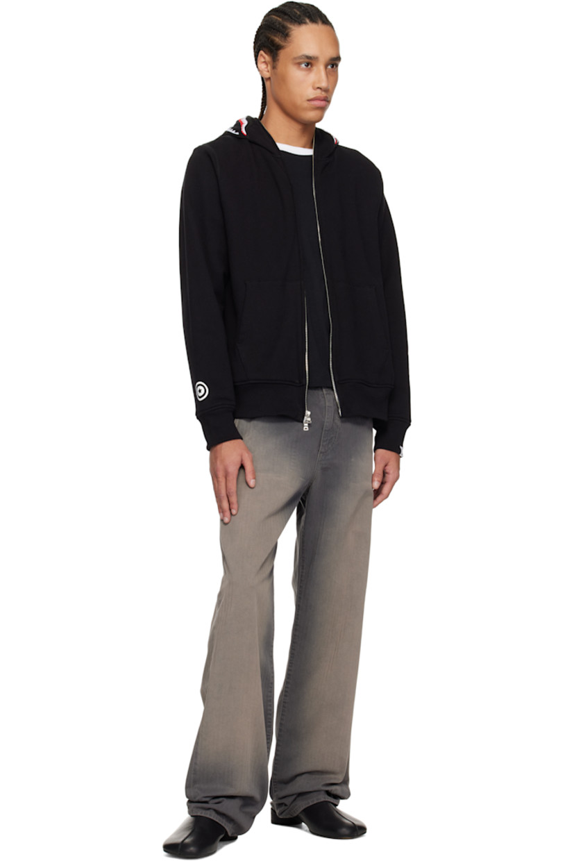 Cotton fleece hoodie. 

· Felted graphic appliqués and embroidered text at hood
· Two-way zip closure extends to hood 
· Patch pockets
· Rib-knit hem and cuffs
· Printed graphic at cuff
· Logo flag at cuff
· Full waffle-knit lining

Supplier color: Black