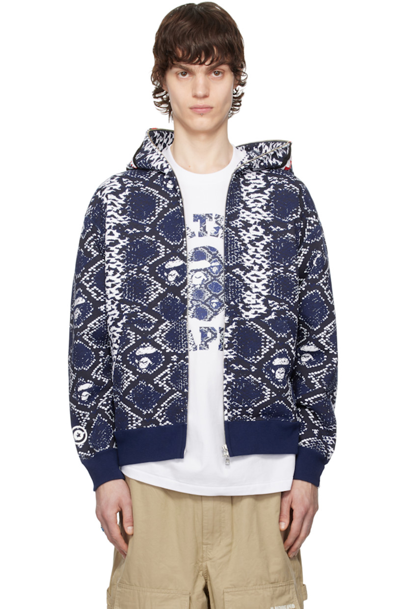 Cotton fleece hoodie. Logo graphic pattern printed throughout.

· Graphic print and appliqués at hood
· Two-way zip closure extends to hood
· Patch pockets
· Rib-knit hem and cuffs
· Graphic printed at sleeve
· Logo flag at cuff

Part of the Lunar New Year collection.

Available exclusively at SSENSE.

Supplier color: Blue