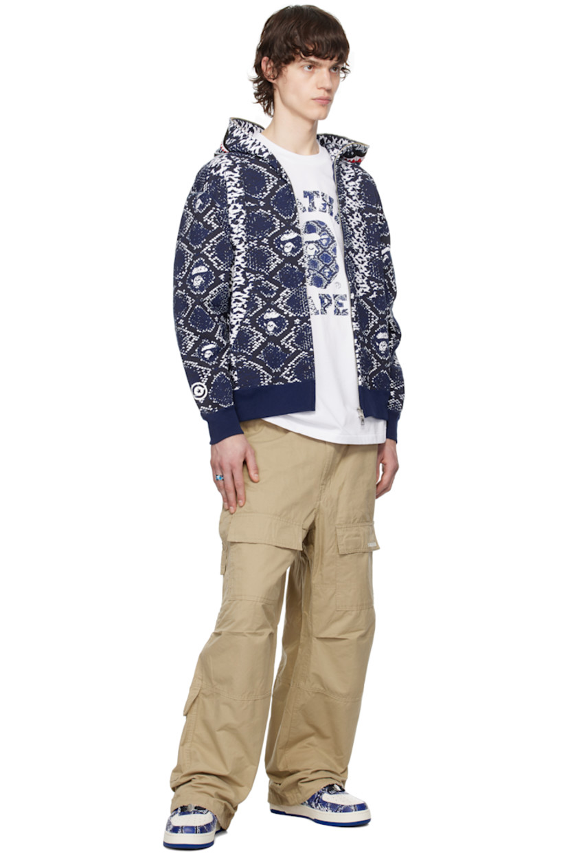 Cotton fleece hoodie. Logo graphic pattern printed throughout.

· Graphic print and appliqués at hood
· Two-way zip closure extends to hood
· Patch pockets
· Rib-knit hem and cuffs
· Graphic printed at sleeve
· Logo flag at cuff

Part of the Lunar New Year collection.

Available exclusively at SSENSE.

Supplier color: Blue