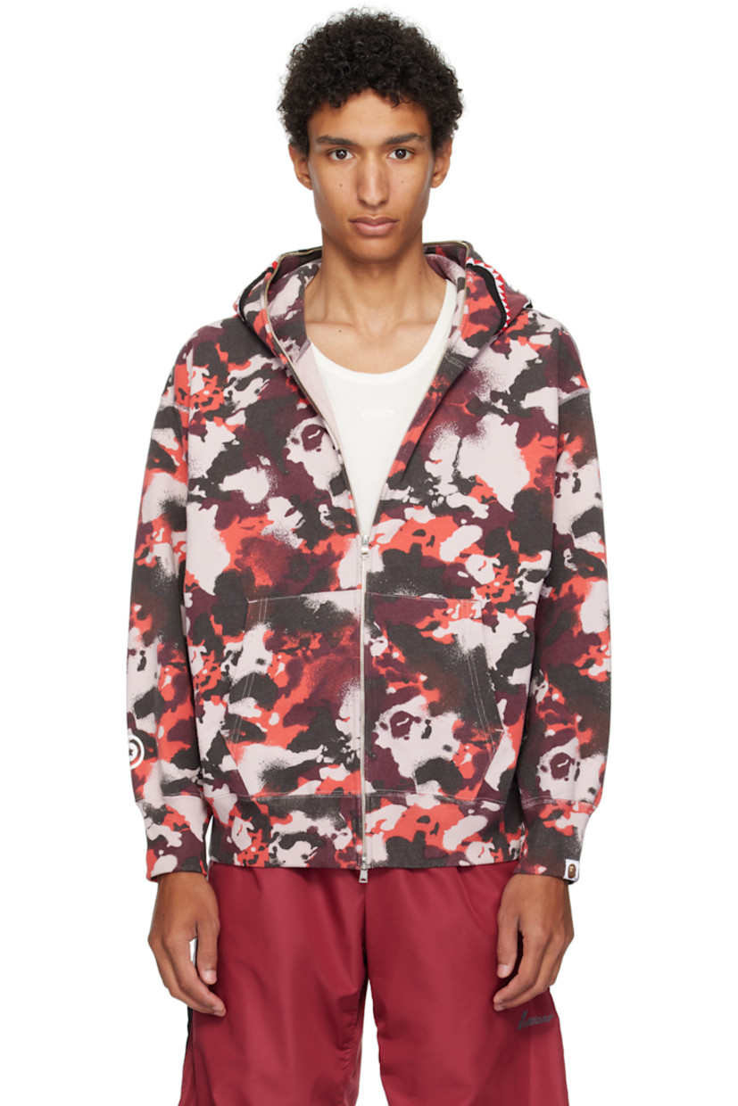 French terry hoodie. 

· Logo camouflage pattern throughout
· Printed graphic and graphic appliqués at hood
· Two-way zip closure extends to hood
· Patch pockets
· Rib-knit hem and cuffs
· Dropped shoulders
· Logo flag at cuff

Supplier color: Red