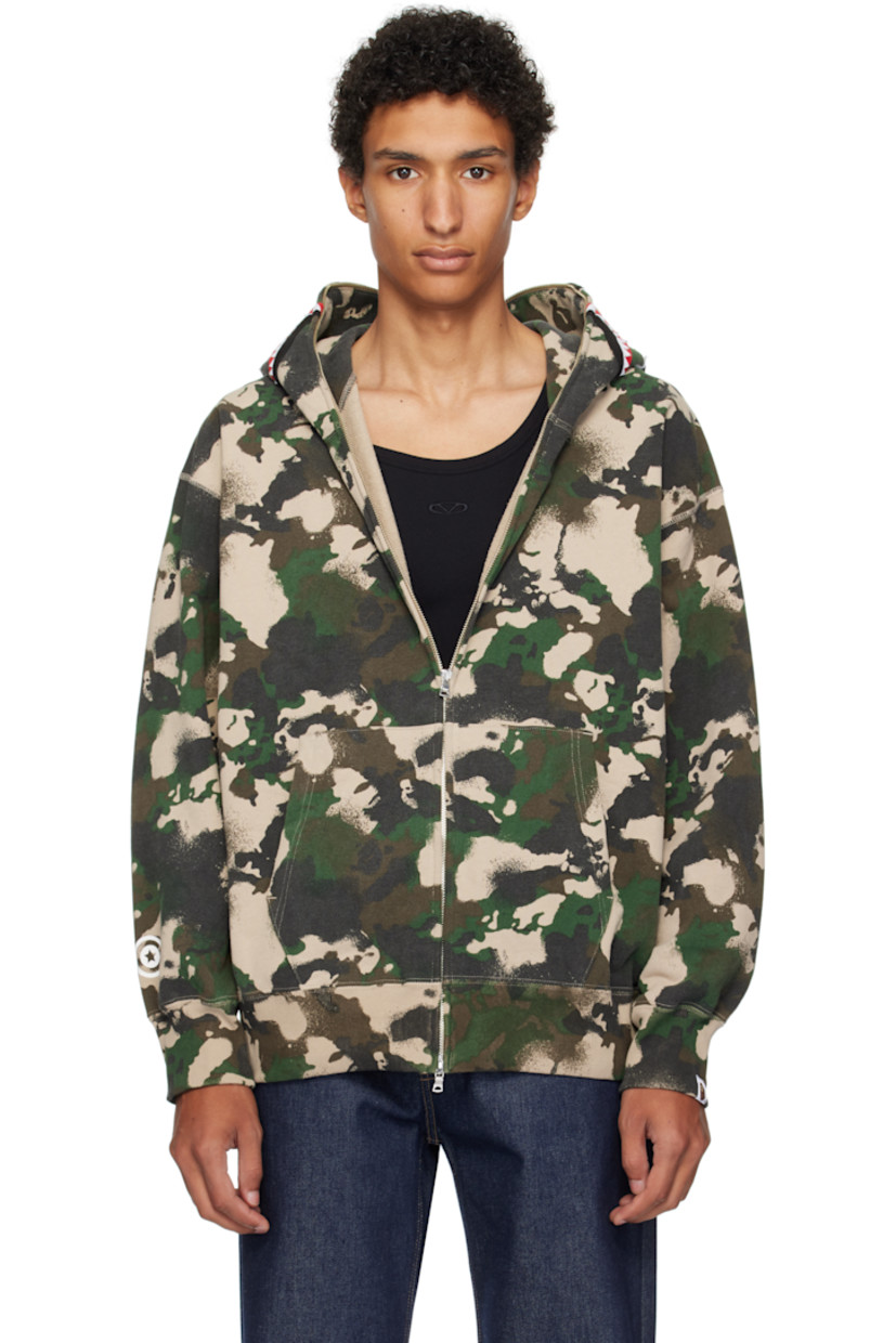 French terry hoodie. 

· Logo camouflage pattern throughout
· Printed graphic and graphic appliqués at hood
· Two-way zip closure extends to hood
· Patch pockets
· Rib-knit hem and cuffs
· Dropped shoulders
· Logo flag at cuff

Supplier color: Green