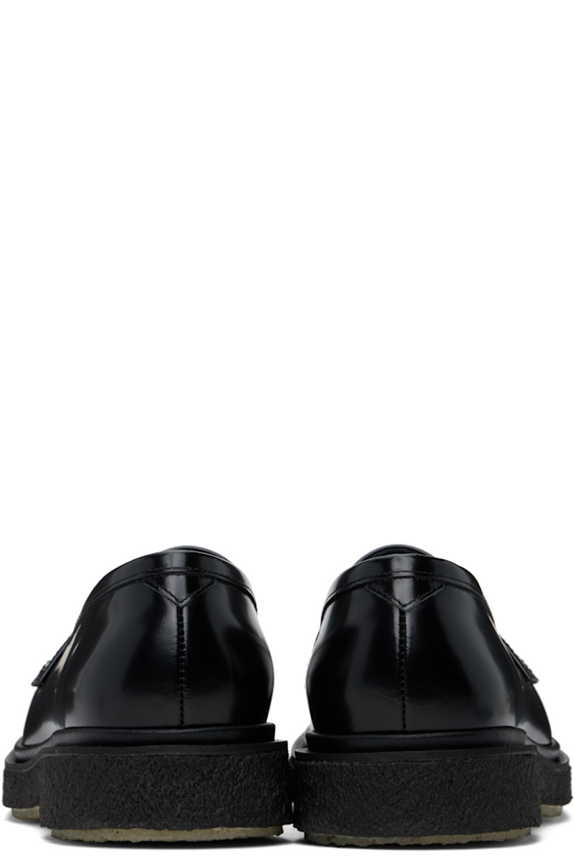 Polished leather loafers in black.

· Moc toe
· Strap with cutout at vamp
· Logo printed at padded leather footbed
· Suede and buffed leather lining
· Crepe rubber sole

Supplier color: Black