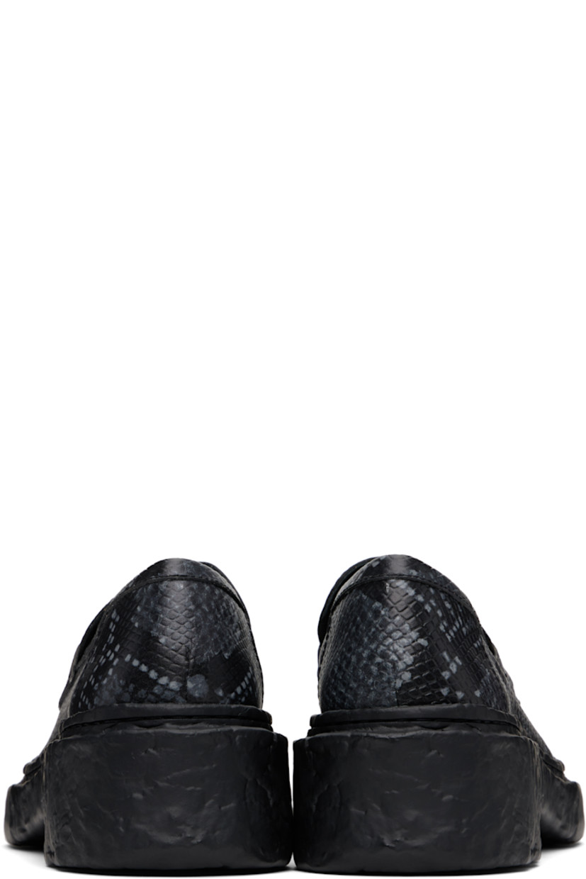 Snake-embossed leather loafers in gray. 

· Moc toe
· Strap with cutout at vamp
· Padded collar
· OrthoLite® Recycled™ footbed
· Buffed leather and suede lining
· Textured midsole and heel
· Textured rubber sole
· Heel: H2"

Supplier color: Gray/Black