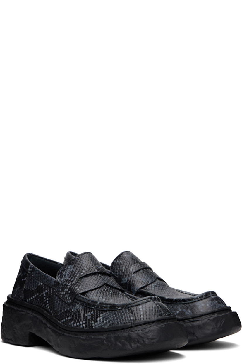 Snake-embossed leather loafers in gray. 

· Moc toe
· Strap with cutout at vamp
· Padded collar
· OrthoLite® Recycled™ footbed
· Buffed leather and suede lining
· Textured midsole and heel
· Textured rubber sole
· Heel: H2"

Supplier color: Gray/Black