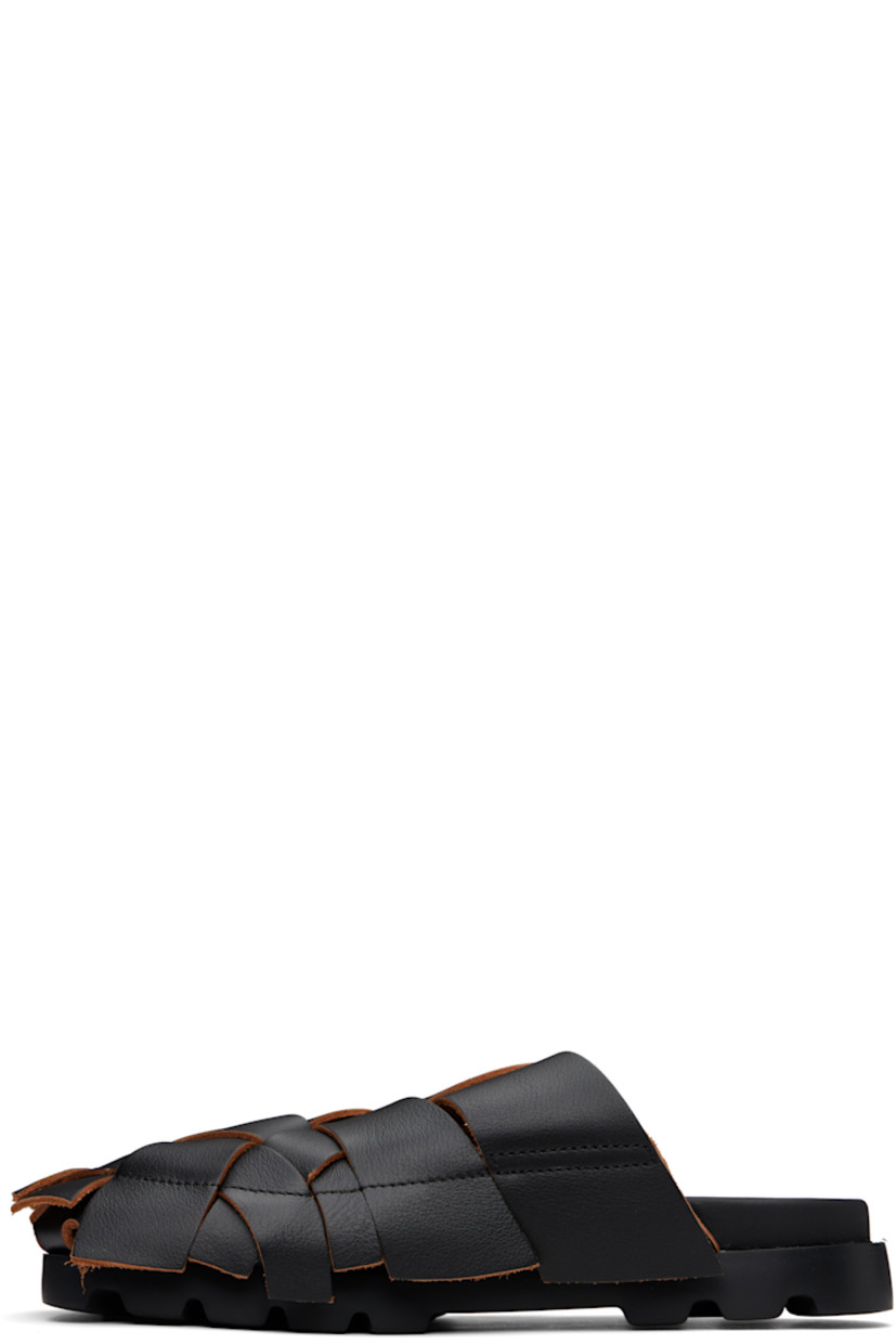 Basket-woven grained leather slip-on sandals in black.

· Extended trim with raw edges throughout
· Suede lining
· Logo printed at faux-leather footbed
· Treaded XL EXTRALIGHT® foam rubber sole

Supplier color: Merco negro/Brutus sand