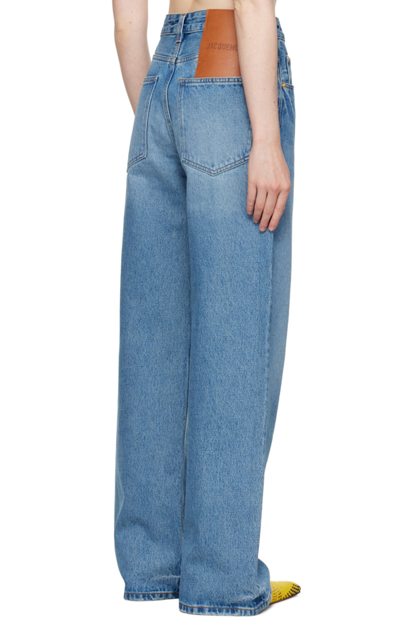 Washed non-stretch denim jeans. Whiskering and subtle distressing throughout. 

· Wide-leg 
· Mid-rise 
· Belt loops
· Logo locker loop at front waistband 
· Five-pocket styling
· Button fly 
· Leather logo patch at back waistband 
· Logo-engraved gold-tone hardware
· Contrast stitching in tan 

Part of the La Croisière collection.

Supplier color: Blue/Tabac