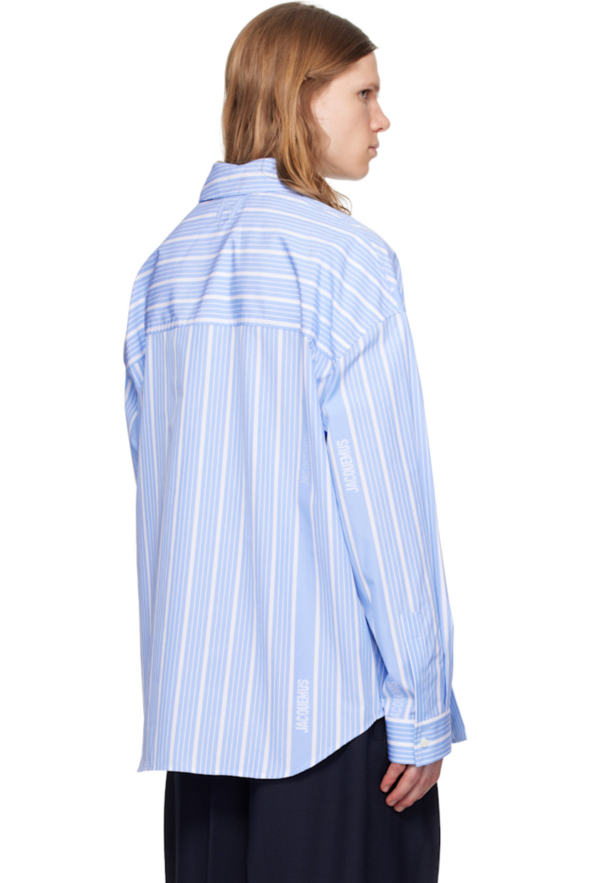 Cotton poplin shirt. Stripes and jacquard logos throughout.

· Asymmetric construction
· Spread collar
· Offset button closure
· Patch pocket at chest
· Shirttail hem
· Buttoned barrel cuffs
· Locker loop at back collar
· Mother-of-pearl hardware

Part of the La Croisière collection.

Supplier color: Jacquard blue/White