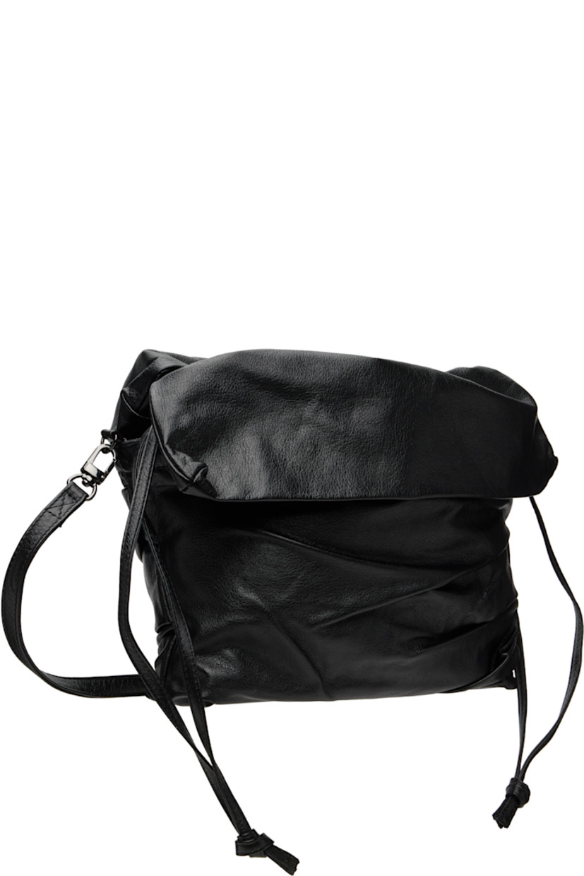 Grained leather shoulder bag.

· Pleating and creasing throughout
· Adjustable and detachable crossbody strap
· Foldover flaps at top
· Drawstring closure
· Patch pocket at interior
· Twill lining
· H8" x W12" x D2.5"

Part of the discord YOHJI YAMAMOTO collection.

Supplier color: Black