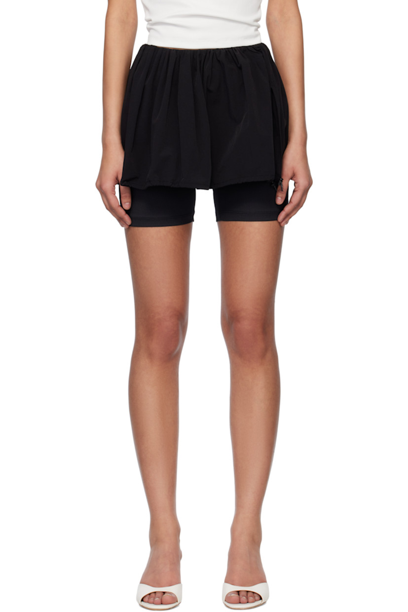 Stretch nylon taffeta skort.

· Mid-rise
· Gathering at elasticized waistband 
· Bungee-style drawstrings and vent at hem
· Full stretch ribbed jersey lining

Supplier color: Black