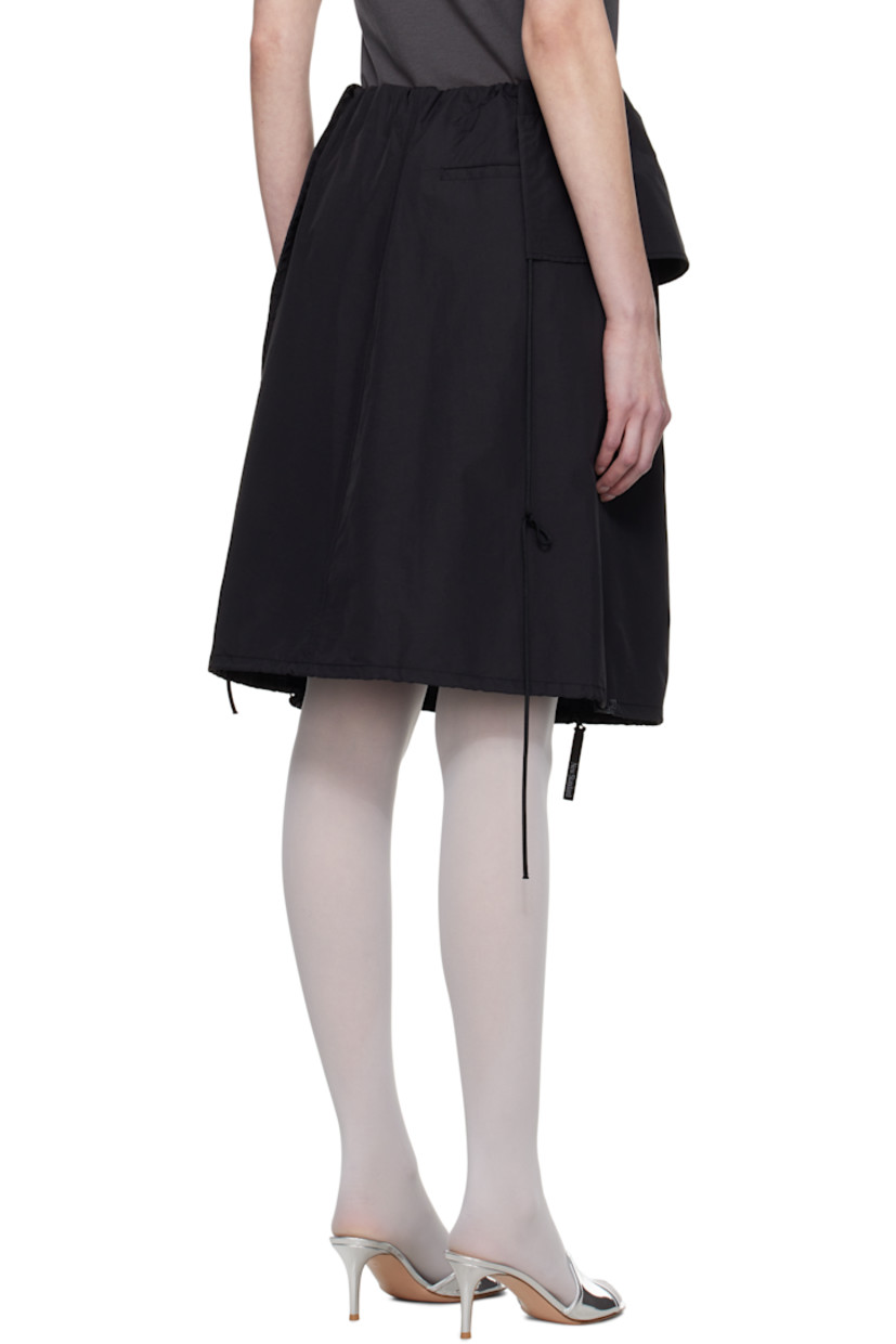 Nylon taffeta midi skirt.

· Layered and asymmetrical construction
· Elasticized waistband
· Four-pocket styling
· Zip closure at front
· Bungee-style drawstring at hem
· Full taffeta lining

Supplier color: Black
