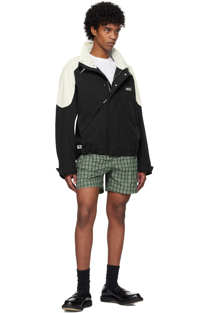 Nylon taffeta jacket.

· Paneled construction
· Stand collar
· Zip closure
· Press-stud placket
· Logo and text embroidered at chest
· Zip pockets
· Concealed bungee-style drawstring at hem
· Logo patch at side seam
· Raglan sleeves
· Velcro tab at cuffs
· Rubberized logo patch at back collar
· Welt pocket at interior
· Mesh lining

Supplier color: Black/Ivory