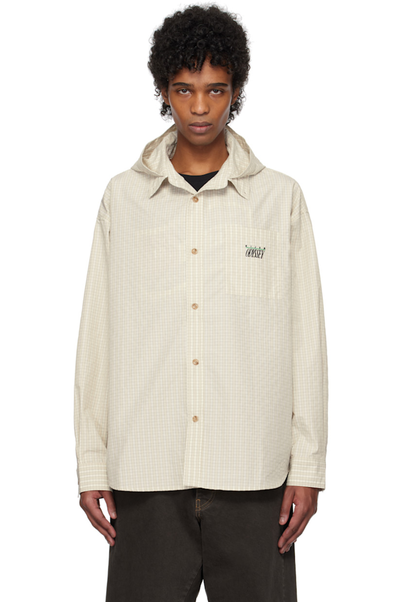 Polyester twill shirt. Check pattern throughout.

· Hood at open spread collar
· Button closure
· Logo and text embroidered at patch pocket
· Shirttail hem
· Dropped shoulders
· Pleat at single-button barrel cuffs
· Locker loop at back collar
· Twin pleats at back yoke

Supplier color: Ivory