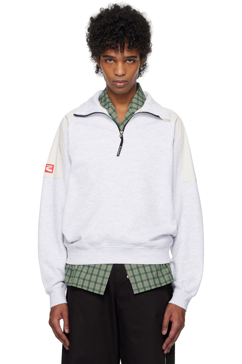 French terry sweatshirt. Twill patches throughout.

· Mock neck
· Half-zip closure
· Rib-knit hem and cuffs
· Raglan sleeves
· Rubberized logo patch at sleeve

Supplier color: Melange/White