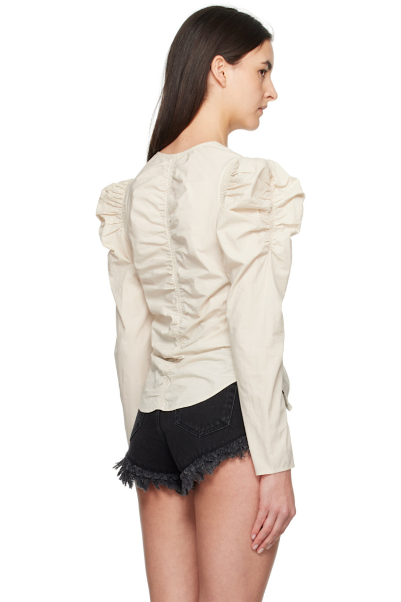 Organic cotton poplin blouse. Ruching throughout.

· V-neck
· Zip closure
· Shirttail hem
· Gigot sleeves

Supplier color: Ecru