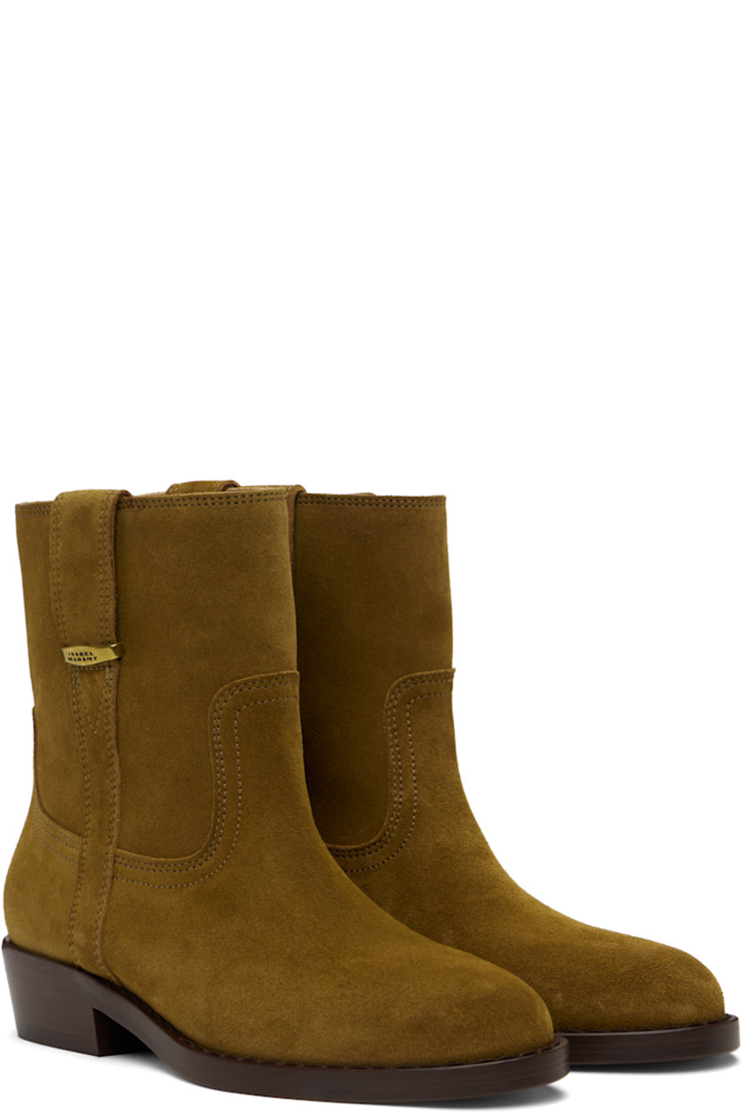 Ankle-high suede calfskin boots in brown.

· Logo-engraved hardware at outer side
· Topstitching at welt
· Nubuck calfskin lining
· Stacked leather heel with rubber injection
· Leather sole
· Heel: H1.25"

Supplier color: Sepia