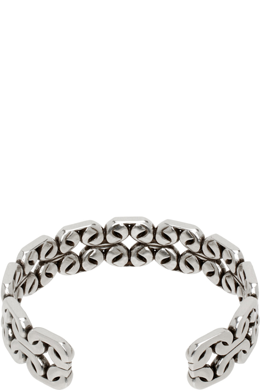 Open cuff bracelet in antiqued silver-tone brass. Graphic detailing throughout.

Supplier color: Silver