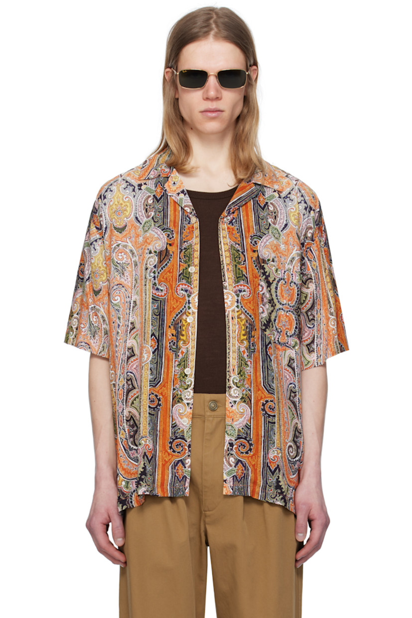Plain-woven viscose shirt. Paisley pattern printed throughout. 

· Open spread collar 
· Button closure 
· Patch pocket at chest 
· Vent at side seams
· Dropped shoulders 
· Twin-pleats at back yoke 
· Mother-of-pearl hardware 

Supplier color: Burnt orange
