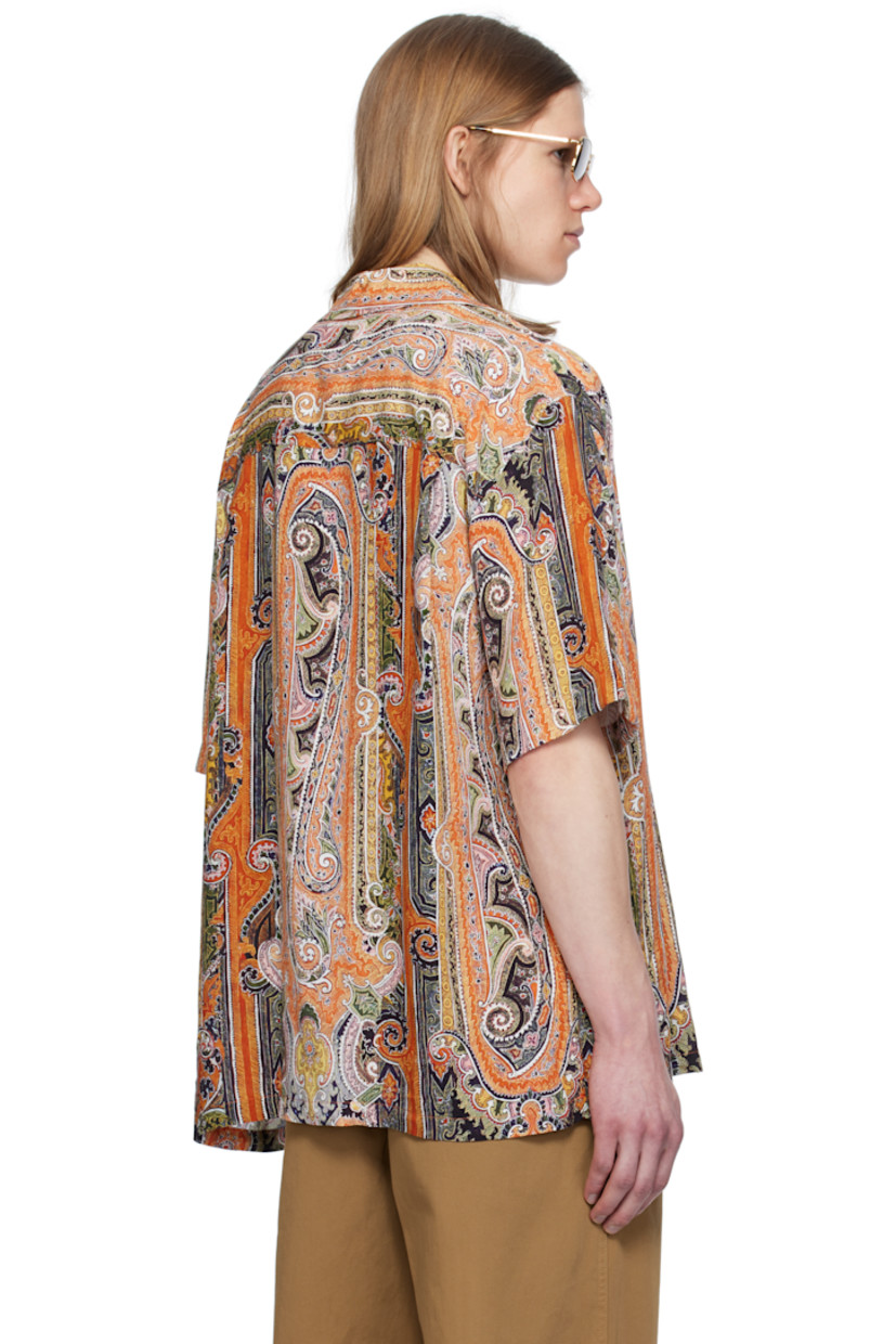 Plain-woven viscose shirt. Paisley pattern printed throughout. 

· Open spread collar 
· Button closure 
· Patch pocket at chest 
· Vent at side seams
· Dropped shoulders 
· Twin-pleats at back yoke 
· Mother-of-pearl hardware 

Supplier color: Burnt orange