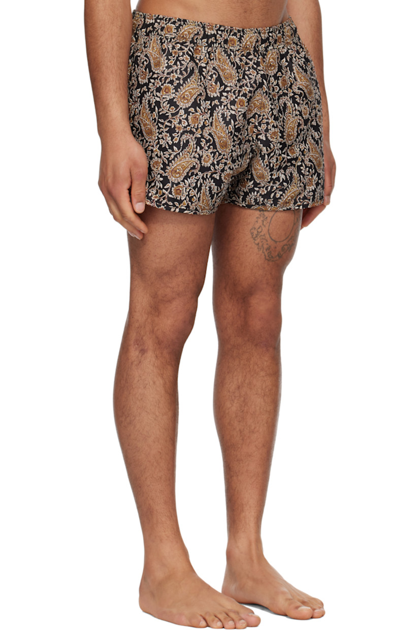 Recycled polyester taffeta swim shorts. Paisley pattern printed throughout.

· Concealed drawstring at elasticized waistband
· Two-pocket styling
· Vented cuffs
· Nylon mesh briefs-style lining

Supplier color: Bkoc/Black/Ochre