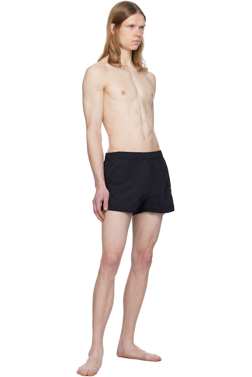 Polyester taffeta swim shorts. 

· Concealed drawstring at elasticized waistband
· Two-pocket styling
· Logo graphic embroidered at leg
· Vent at cuffs 
· Briefs-style mesh lining

Supplier color: Faded black