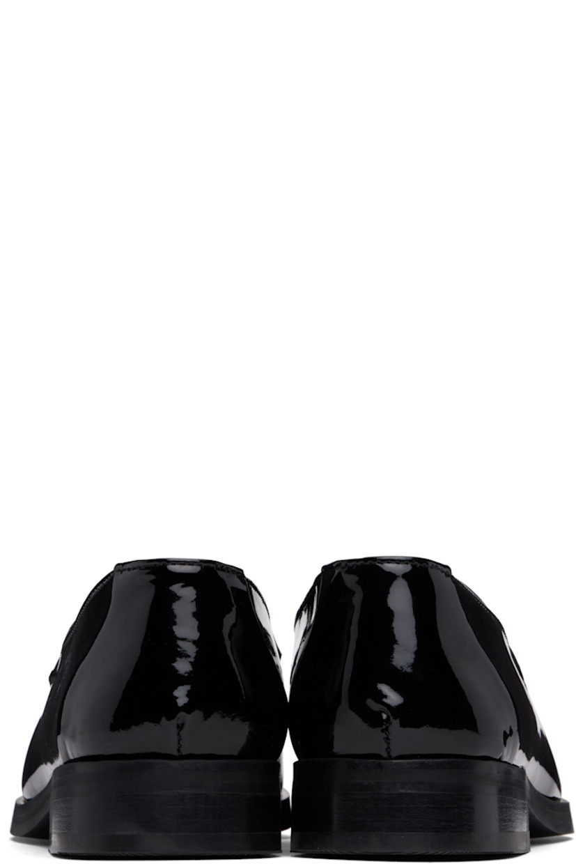 Patent calfskin loafers in black.

· Moc toe
· Strap at vamp
· Buffed leather and suede lining
· Stacked leather heel with rubber injection
· Smooth leather sole

Supplier color: Black patent leather