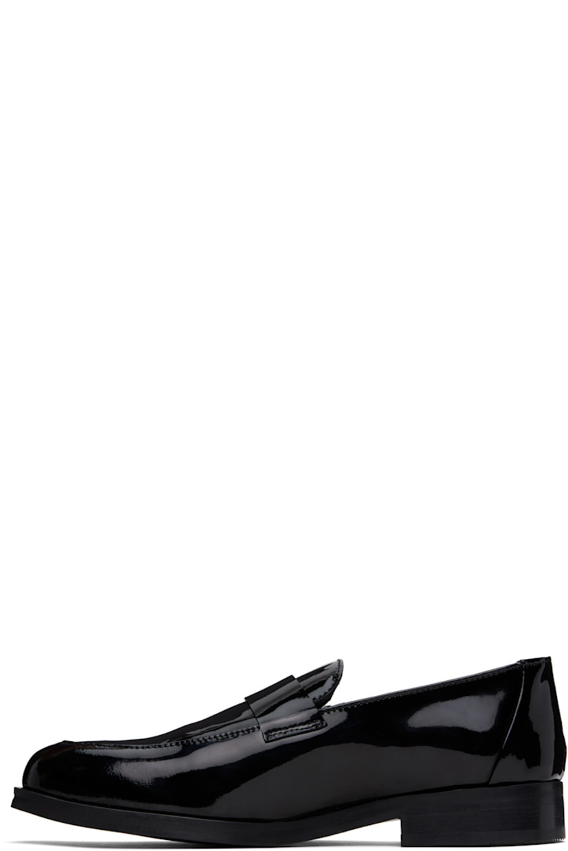 Patent calfskin loafers in black.

· Moc toe
· Strap at vamp
· Buffed leather and suede lining
· Stacked leather heel with rubber injection
· Smooth leather sole

Supplier color: Black patent leather