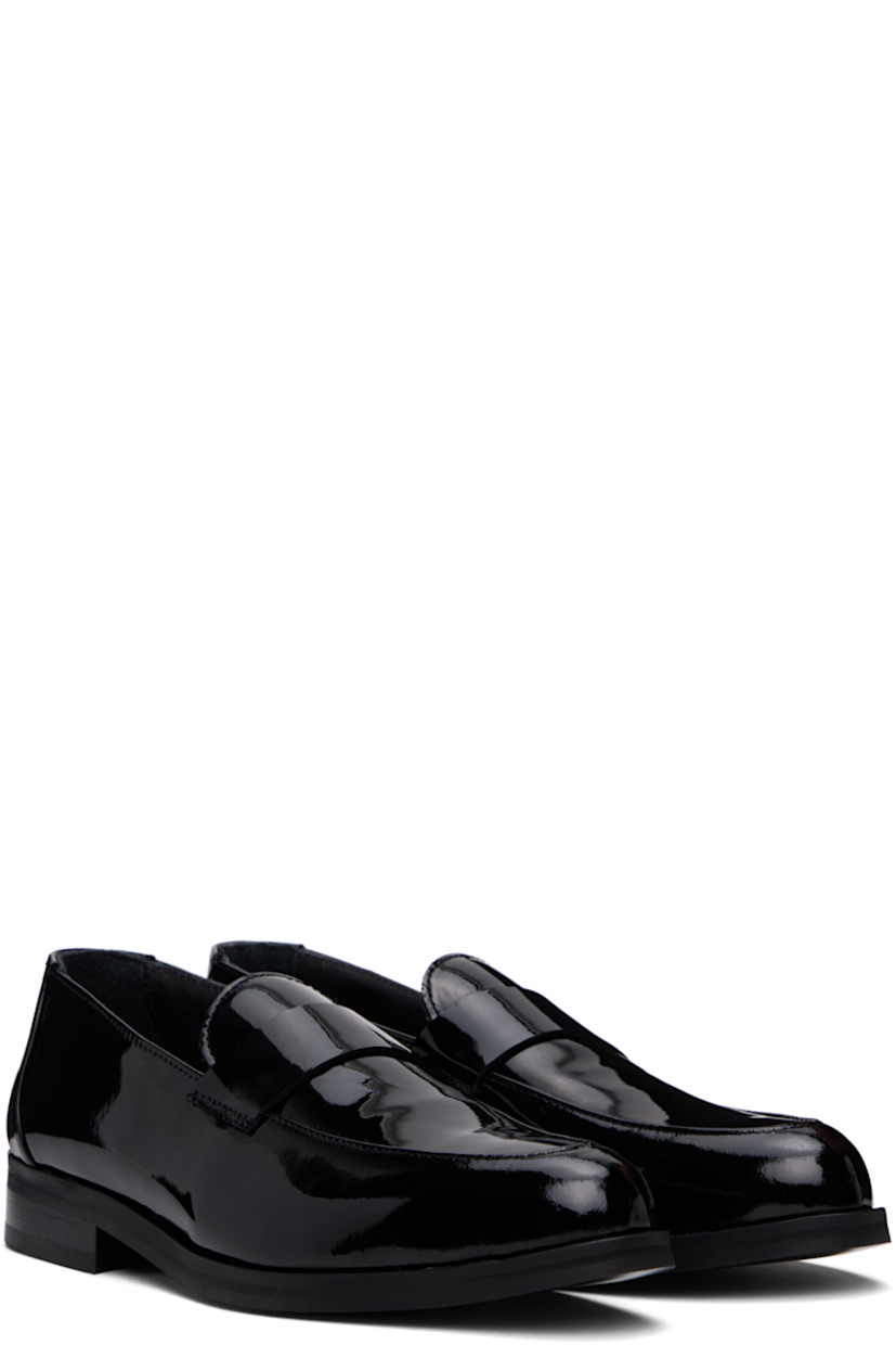 Patent calfskin loafers in black.

· Moc toe
· Strap at vamp
· Buffed leather and suede lining
· Stacked leather heel with rubber injection
· Smooth leather sole

Supplier color: Black patent leather