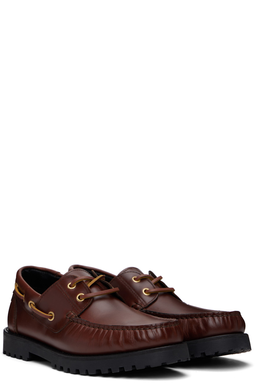 Buffed calfskin boat shoes in brown.

· Moc toe
· Lace-up closure
· Lace-up detailing at collar
· Buffed leather lining
· Foam rubber heel and midsole
· Treaded rubber sole

Supplier color: Brown leather
