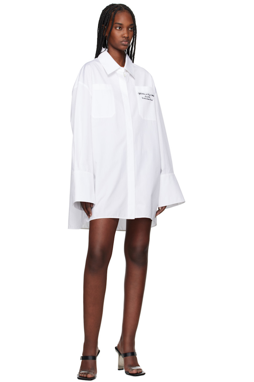 Cotton poplin shirt-style minidress. 

· Spread collar
· Button closure
· Logo and text embroidered at patch pocket
· Shirttail hem
· Logo flag at side seam
· Dropped shoulders
· Pleated single-button barrel cuffs

Supplier color: White/Black