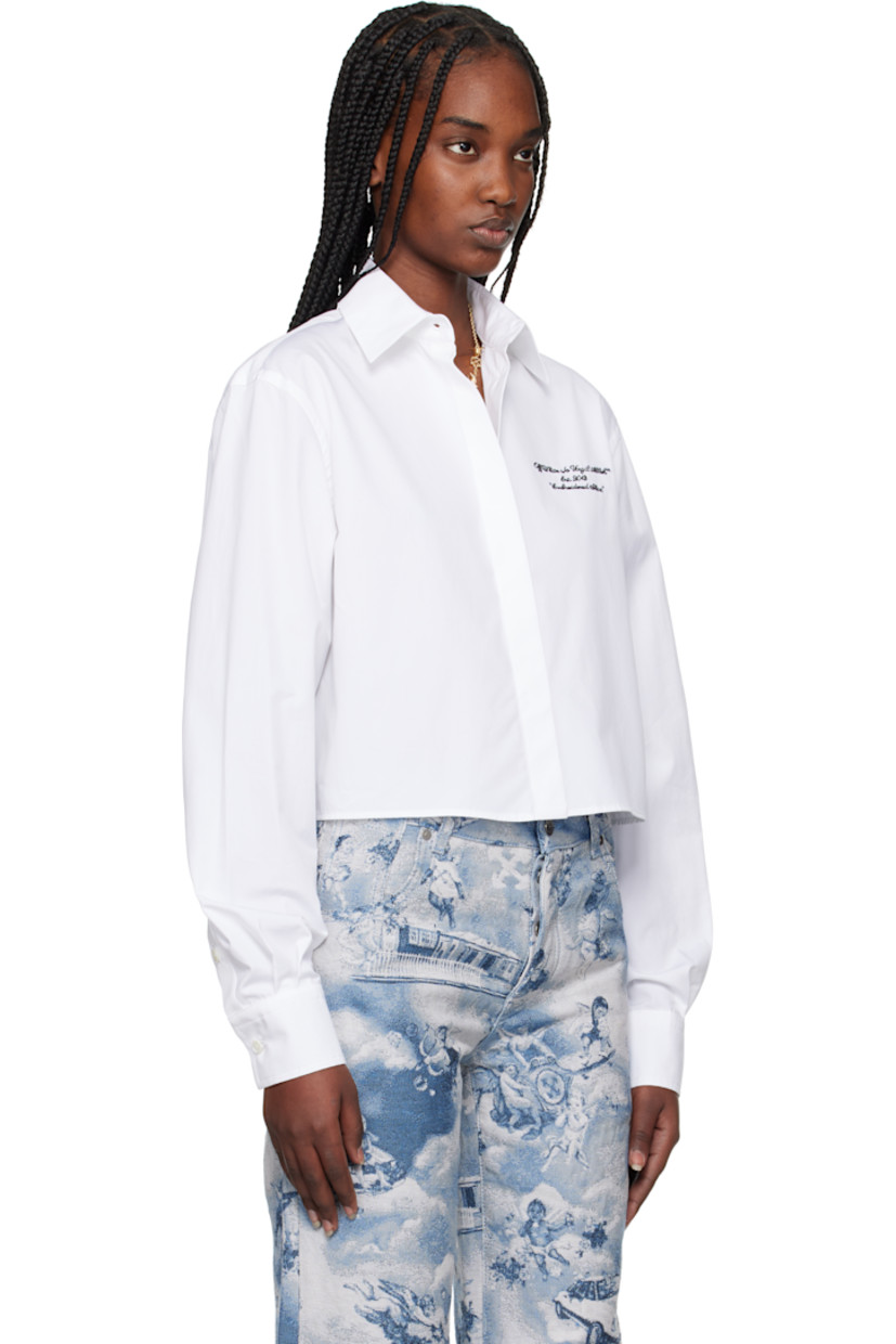 Cotton poplin shirt. 

· Boxy-fit
· Spread collar
· Concealed button closure
· Logo and text embroidered at chest
· Cropped hem
· Logo flag at side seam
· Pleated single-button barrel cuffs

Supplier color: White/Black