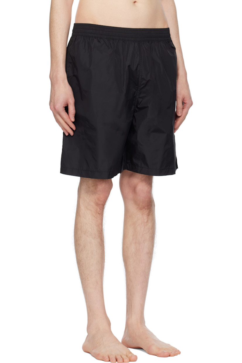 Nylon taffeta swim shorts.

· Concealed drawstring at elasticized waistband
· Three-pocket styling
· Logo printed at front
· Vented outseams
· Logo graphic printed at back
· Partial mesh lining

Supplier color: Black/White