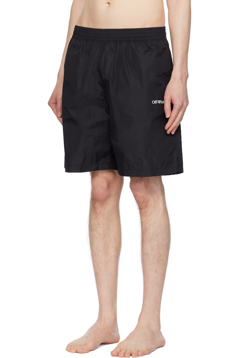 Nylon taffeta swim shorts.

· Concealed drawstring at elasticized waistband
· Three-pocket styling
· Logo printed at front
· Vented outseams
· Logo graphic printed at back
· Partial mesh lining

Supplier color: Black/White