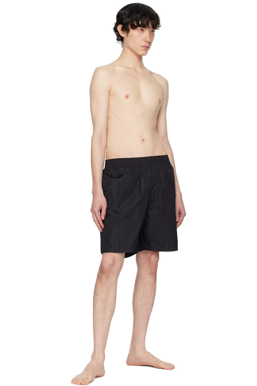 Nylon taffeta swim shorts.

· Concealed drawstring at elasticized waistband
· Three-pocket styling
· Logo printed at front
· Vented outseams
· Logo graphic printed at back
· Partial mesh lining

Supplier color: Black/White