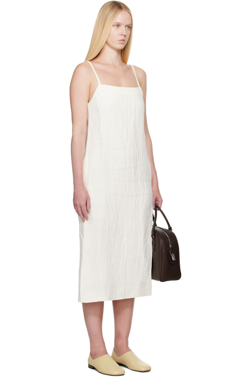 Textured linen- and cotton-blend double-gauze midi dress.

· Square neck
· Seam pockets
· Fixed spaghetti straps
· Concealed zip closure at back
· Central vent at back hem
· Full viscose-blend twill lining

Supplier color: Parchment