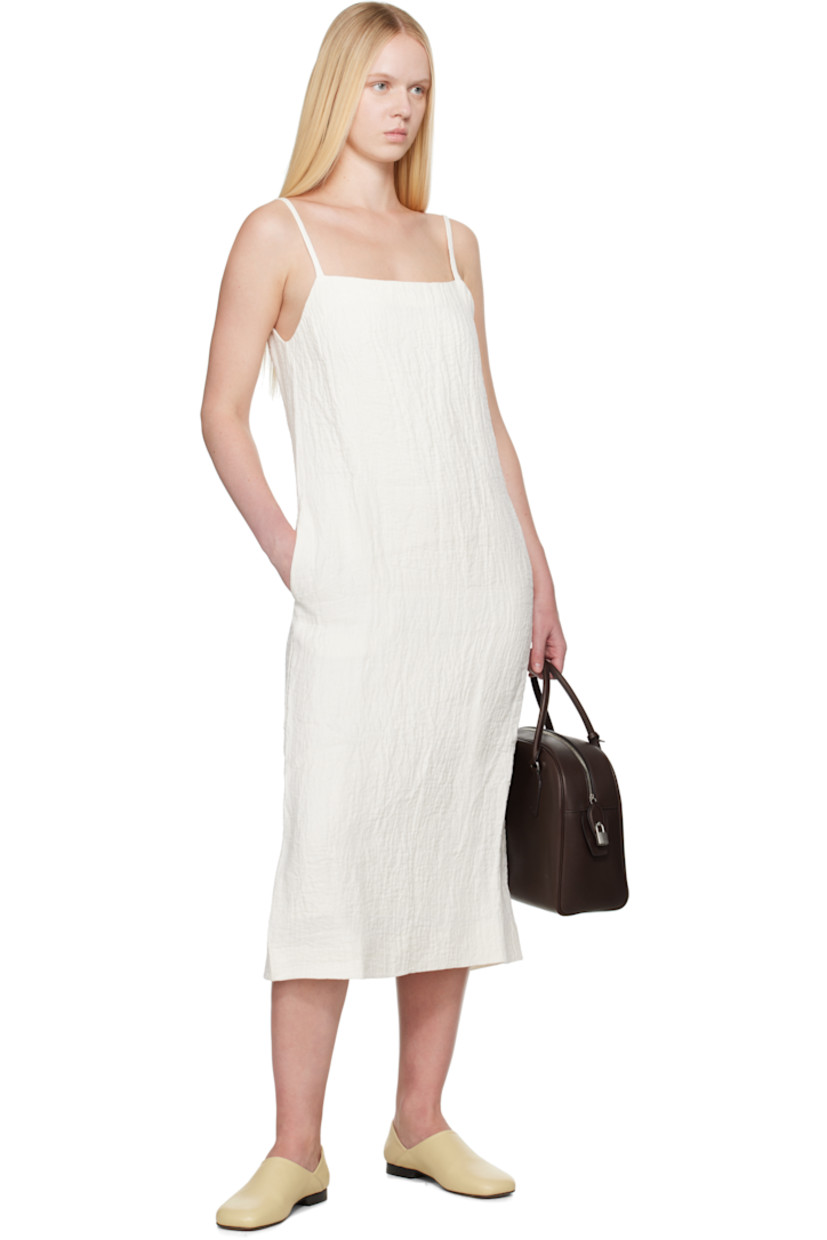Textured linen- and cotton-blend double-gauze midi dress.

· Square neck
· Seam pockets
· Fixed spaghetti straps
· Concealed zip closure at back
· Central vent at back hem
· Full viscose-blend twill lining

Supplier color: Parchment