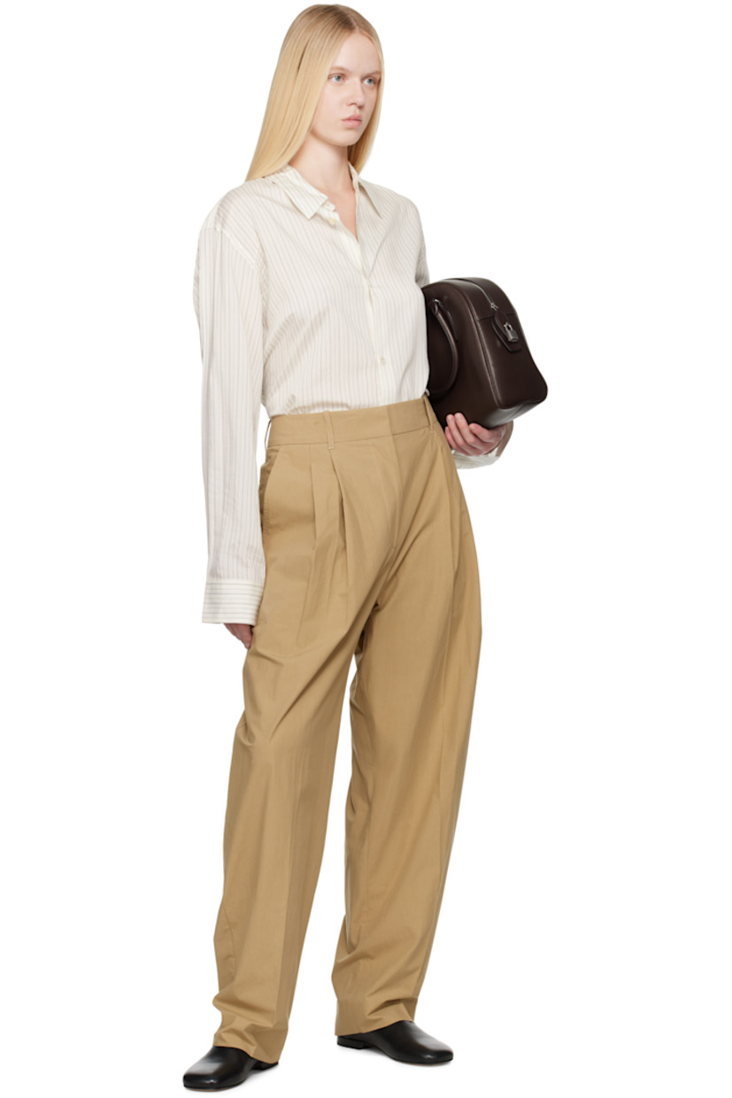 Boxy-fit silk- and cotton-blend voile shirt. Pinstripes throughout.

· Spread collar
· Button closure
· Shirttail hem
· Buttoned barrel cuffs
· Twin pleats at back yoke
· Mother-of-pearl hardware

Supplier color: Ecru/Black