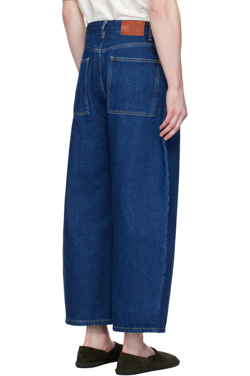 Wide-leg 14 oz non-stretch regenerative cotton-blend denim jeans. 

· Belt loops
· Five-pocket styling
· Zip fly
· Leather logo patch at back waistband
· Contrast stitching in tan

Supplier color: Indigo wash