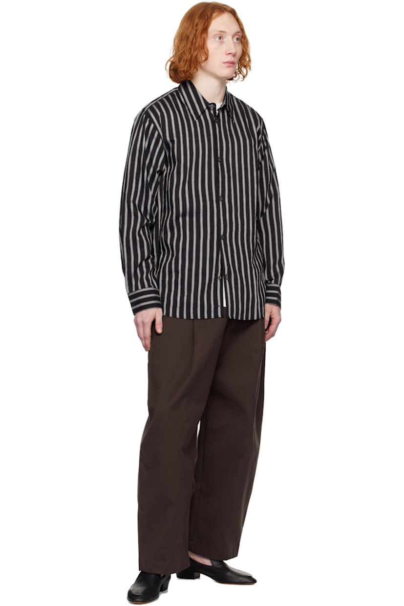 Oversized lyocell- and nylon-blend poplin shirt. Stripes throughout.

· Boxy-fit
· Spread collar
· Button closure
· Shirttail hem
· Dropped shoulders
· Pleat at single-button barrel cuffs
· Twin pleats at back yoke

Supplier color: Darkest navy