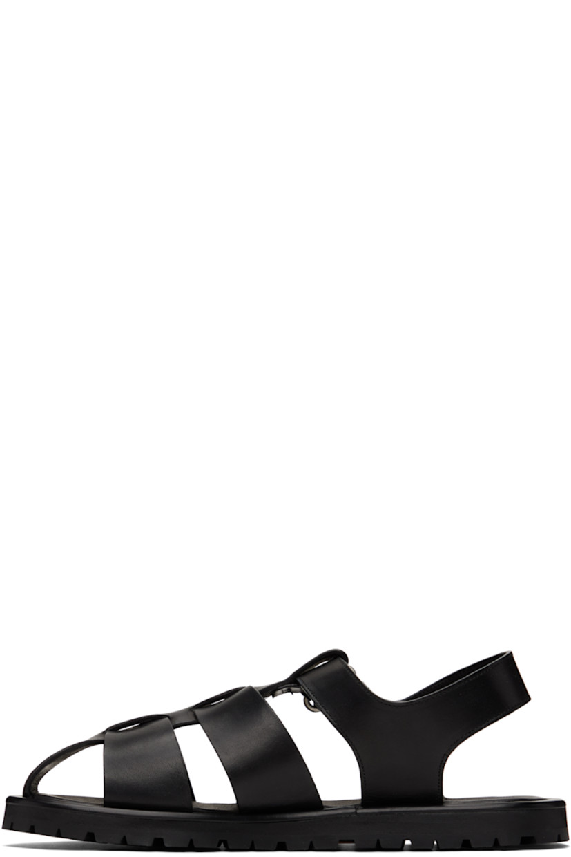 Buffed calfskin flat sandals in black.

· Velcro ankle strap
· Logo stamp at padded footbed
· Buffed leather lining
· Treaded Vibram® rubber sole

Supplier color: Black
