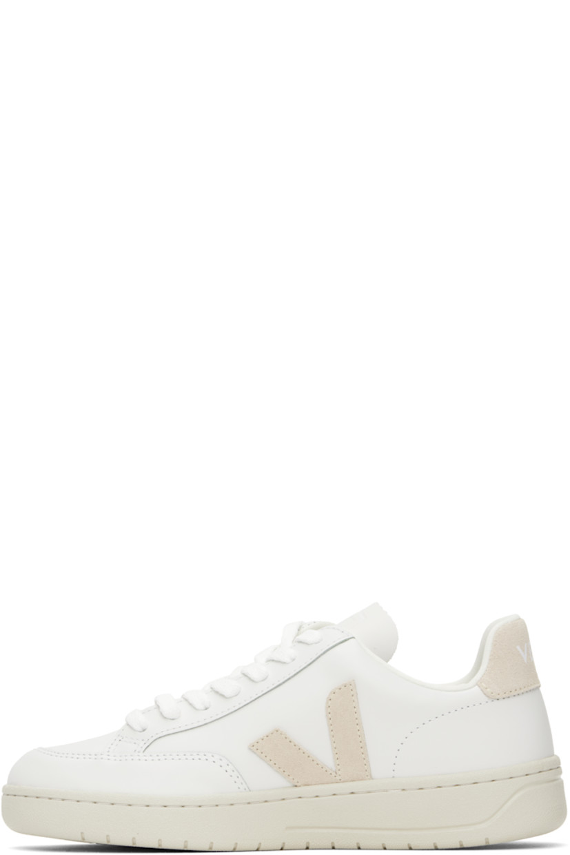 Low-top buffed leather sneakers in white.

· Lace-up closure
· Logo embossed at tongue
· Padded collar
· Suede logo appliqué at sides
· Text embossed at outer side
· Logo printed at suede heel tab
· Recycled polyester jersey lining
· Treaded rubber sole

Supplier color: Extra-white/Sable