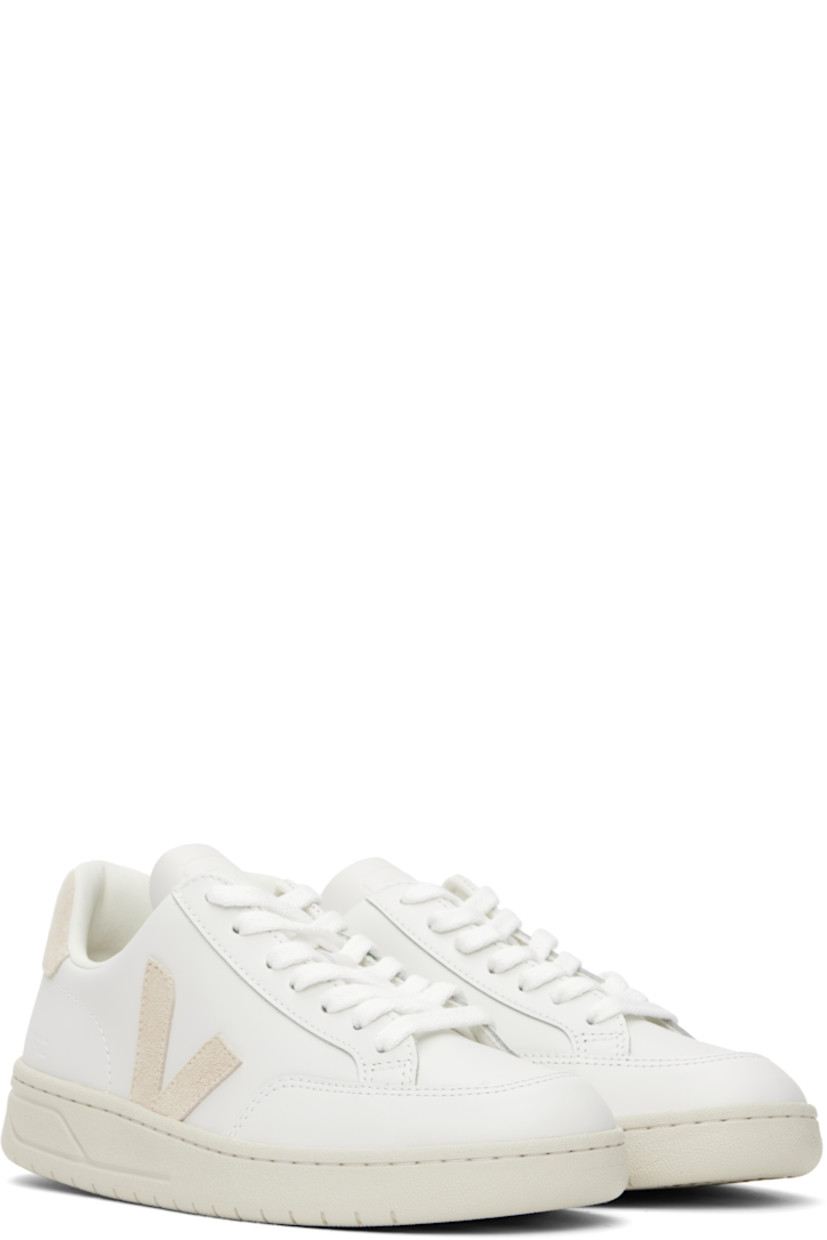 Low-top buffed leather sneakers in white.

· Lace-up closure
· Logo embossed at tongue
· Padded collar
· Suede logo appliqué at sides
· Text embossed at outer side
· Logo printed at suede heel tab
· Recycled polyester jersey lining
· Treaded rubber sole

Supplier color: Extra-white/Sable