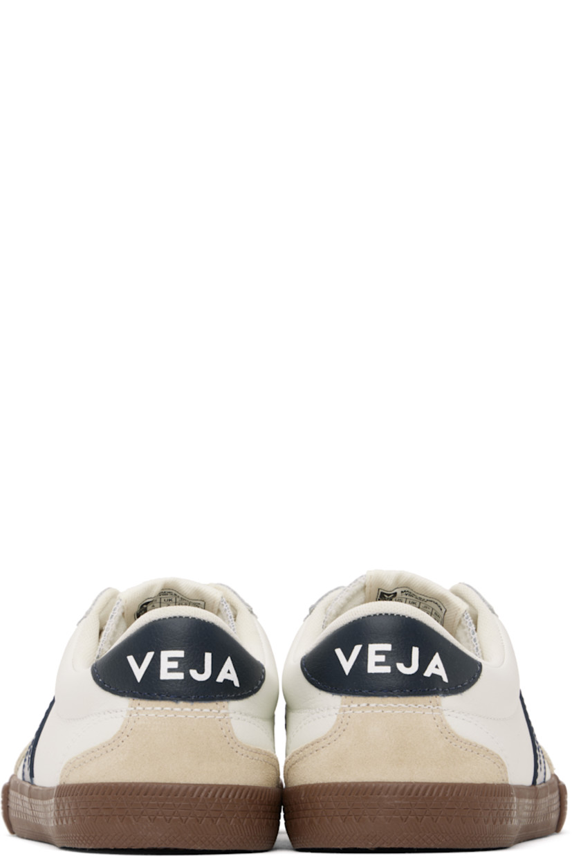 Low-top grained organic leather and suede sneakers in white. 

· Perforated detailing at toe
· Serrated trim at lace-up closure
· Logo patch at padded tongue
· Padded collar
· Logo appliqué at sides
· Logo printed at heel tab
· Recycled polyester jersey lining
· Treaded rubber sole

Supplier color: White/Nautico/Bark