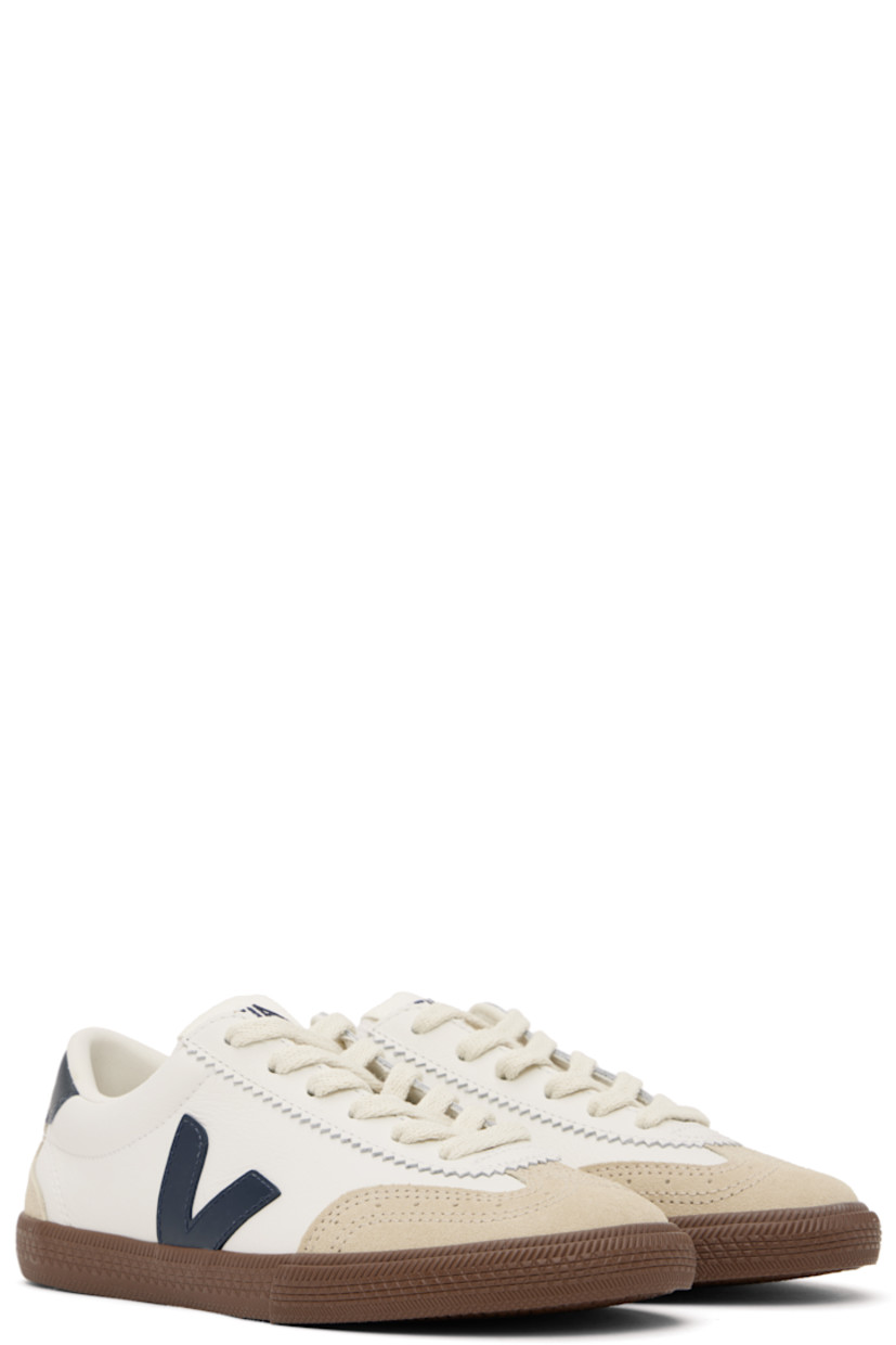 Low-top grained organic leather and suede sneakers in white. 

· Perforated detailing at toe
· Serrated trim at lace-up closure
· Logo patch at padded tongue
· Padded collar
· Logo appliqué at sides
· Logo printed at heel tab
· Recycled polyester jersey lining
· Treaded rubber sole

Supplier color: White/Nautico/Bark